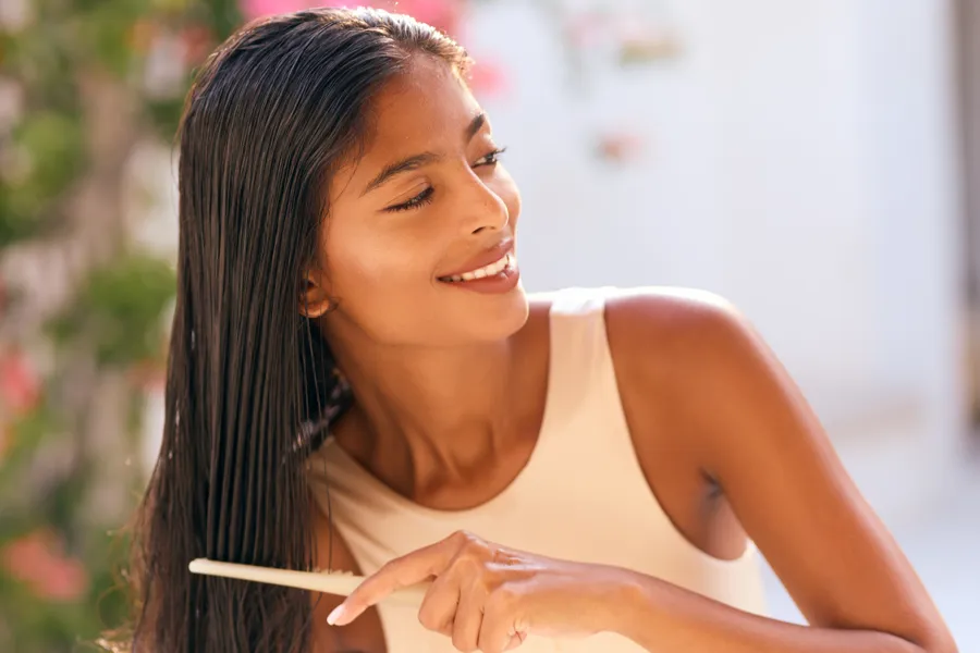 Woman brushing glossy hair